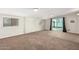 Spacious living room featuring a brick accent wall and access to the backyard at 101 W Shannon St, Chandler, AZ 85225