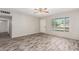 Living area with wood-look tile, ceiling fan and a view of the front yard at 101 W Shannon St, Chandler, AZ 85225