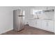 Modern kitchen with white cabinets and stainless steel fridge at 1917 W Ashland Ave, Phoenix, AZ 85009