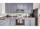 Modern kitchen with stainless steel appliances and gray cabinets at 804 W St Anne Ave, Phoenix, AZ 85041