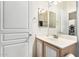 Neat bathroom with a vanity sink, mirror, and wood cabinets at 804 W St Anne Ave, Phoenix, AZ 85041