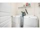 Functional laundry room with washer, dryer, and storage shelves at 804 W St Anne Ave, Phoenix, AZ 85041