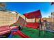 Relaxing backyard with red couch, swing, and play area at 804 W St Anne Ave, Phoenix, AZ 85041