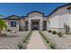 Stunning curb appeal! This home features a white exterior, landscaped yard, and a welcoming walkway at 4584 N 192Nd Dr, Litchfield Park, AZ 85340