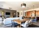 Open dining area with a wood table, modern chairs and views into the living room and kitchen at 18518 W Acacia Dr, Goodyear, AZ 85338