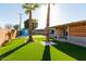 Spacious backyard oasis with artificial turf and mature palm trees at 2009 N 68Th St, Scottsdale, AZ 85257