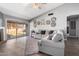 Spacious living room featuring hardwood floors, a fireplace, and sliding glass doors leading to the backyard at 11227 N 59Th Dr, Glendale, AZ 85304