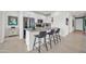 Modern kitchen with white cabinets, stainless steel appliances, and an island at 18011 W Muirwood Dr, Goodyear, AZ 85338