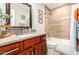 Bathroom with wood vanity, granite countertop, and a bathtub at 907 E 9Th Ave, Mesa, AZ 85204