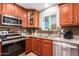 Kitchen with stainless steel appliances, wood cabinets, and granite countertops at 907 E 9Th Ave, Mesa, AZ 85204