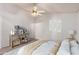 Virtually staged bedroom with ceiling fan and wood accent table at 542 S Higley Rd # 99, Mesa, AZ 85206