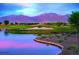 Scenic golf course with water features and mountain views at 17640 W Guthrie St, Surprise, AZ 85388