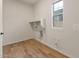 Bright laundry room, featuring wood-look tile flooring and built-in shelving at 22452 E Orchard Ln, Queen Creek, AZ 85142