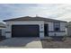 Charming single-story home with a dark-colored garage door and a gray tiled roof at 5601 E Arctic Ln, San Tan Valley, AZ 85140