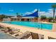 Community pool with a shaded seating area and lounge chairs at 4307 E Jesse St, Gilbert, AZ 85295