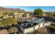 Aerial view of a kidney shaped pool with a large backyard, and desert mountain views at 146 S La Barge Rd, Apache Junction, AZ 85119