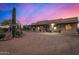 Spanish style home with covered porch at dusk at 146 S La Barge Rd, Apache Junction, AZ 85119