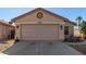 House exterior, featuring a two-car garage and desert landscaping at 44043 W Cypress Ln, Maricopa, AZ 85138