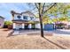 Two-story home with gray garage door and mature tree in front at 10847 E Forge Cir, Mesa, AZ 85208