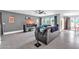 Living room with leather couches and large TV, adjacent to dining area at 10847 E Forge Cir, Mesa, AZ 85208