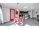 Bright dining area with glass table and red chairs, adjacent to kitchen at 10847 E Forge Cir, Mesa, AZ 85208