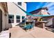 Outdoor patio with seating area and built-in grill at 10847 E Forge Cir, Mesa, AZ 85208