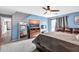 Primary bedroom with a large bed, full-length mirror, and views to hallway at 10847 E Forge Cir, Mesa, AZ 85208