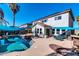 Relaxing pool area with a patio, outdoor kitchen, and shade sails at 10847 E Forge Cir, Mesa, AZ 85208