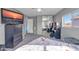 Spacious bedroom with a queen-size bed and large TV at 10847 E Forge Cir, Mesa, AZ 85208