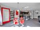 Bright kitchen with red sliding barn door and glass dining table at 10847 E Forge Cir, Mesa, AZ 85208
