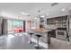 Modern kitchen with granite island, stainless steel appliances, and red accents at 10847 E Forge Cir, Mesa, AZ 85208