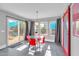 Breakfast nook with glass table and red chairs, overlooking backyard at 10847 E Forge Cir, Mesa, AZ 85208