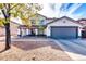 Two-story house with gray garage door and desert landscaping at 10847 E Forge Cir, Mesa, AZ 85208
