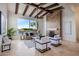 Living area with high ceilings, exposed beams, and a cozy fireplace at 8599 E Sand Flower Dr, Scottsdale, AZ 85266