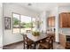 Bright kitchen nook features a wood table and chairs, plus a view of the backyard at 27808 N Desierto Dr, Rio Verde, AZ 85263