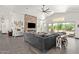 Open concept living room showcasing a cozy sectional sofa and stone fireplace at 27808 N Desierto Dr, Rio Verde, AZ 85263