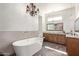 Luxurious bathroom with a freestanding soaking tub, double vanity, and elegant chandelier at 27808 N Desierto Dr, Rio Verde, AZ 85263
