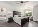 Spacious bedroom with a large bed, dark wood furniture, and ceiling fan at 27808 N Desierto Dr, Rio Verde, AZ 85263
