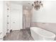 Spa-like bathroom with a soaking tub, shower, and neutral color scheme at 27808 N Desierto Dr, Rio Verde, AZ 85263
