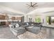 Large living room featuring an L-shaped sectional and open kitchen view at 27808 N Desierto Dr, Rio Verde, AZ 85263