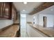 Long granite countertop wet bar with wood cabinets at 10233 E Caron St, Scottsdale, AZ 85258