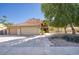 Two-story home with three-car garage, a tile roof and nicely landscaped front yard at 10233 E Caron St, Scottsdale, AZ 85258