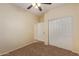 Bright bedroom featuring a ceiling fan and double door closet at 6321 S Teresa Dr, Chandler, AZ 85249