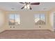 Spacious bedroom with two windows and ceiling fan at 6321 S Teresa Dr, Chandler, AZ 85249