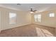Well-lit bedroom with ceiling fan and carpet at 6321 S Teresa Dr, Chandler, AZ 85249