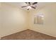 Spacious bedroom with ceiling fan and carpet flooring at 6321 S Teresa Dr, Chandler, AZ 85249