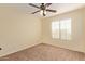 Well-lit bedroom featuring a ceiling fan and carpet at 6321 S Teresa Dr, Chandler, AZ 85249