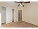 Bedroom with ceiling fan, closet, and access to hallway at 6321 S Teresa Dr, Chandler, AZ 85249