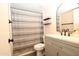Updated bathroom with gray vanity, new fixtures and striped shower curtain at 3119 W Cochise Dr # 106, Phoenix, AZ 85051