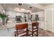 Kitchen with a breakfast bar, white cabinets, and stainless steel appliances at 2324 E Shea Blvd, Phoenix, AZ 85028